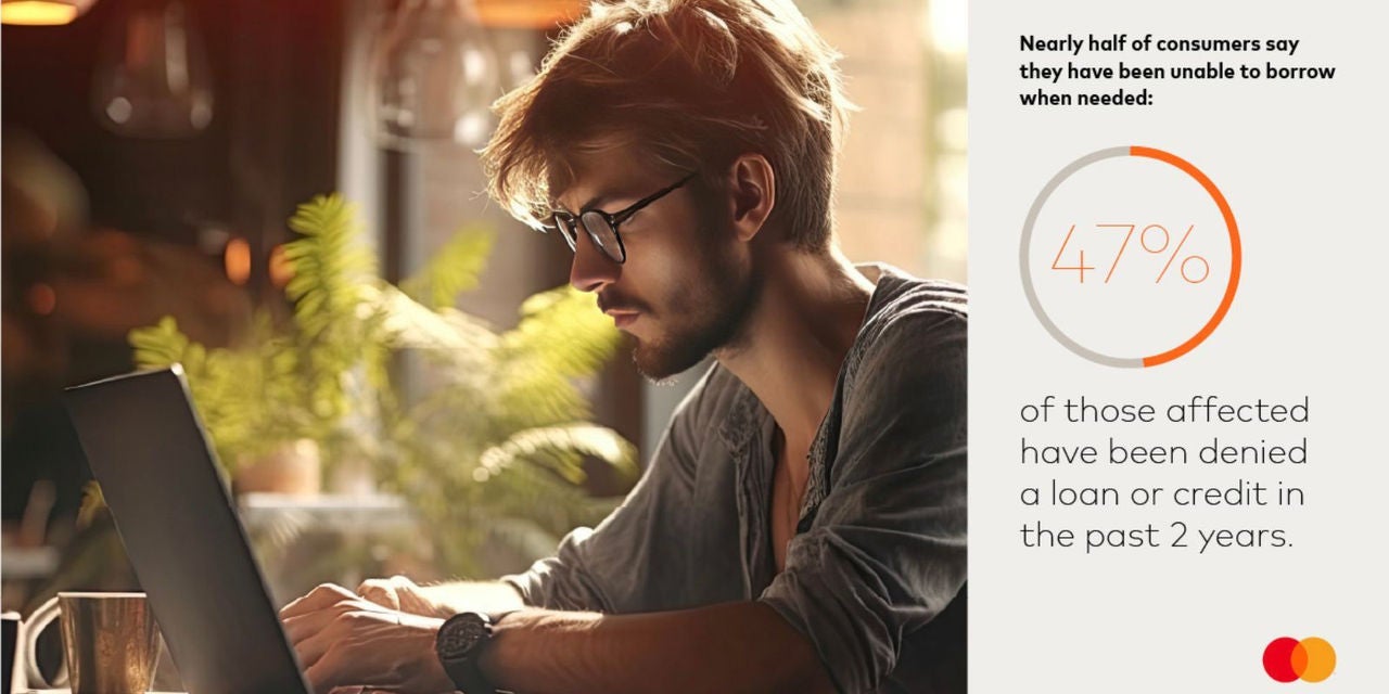 Man on computer next to statistic