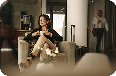 Businesswoman having coffee at airport lounge.