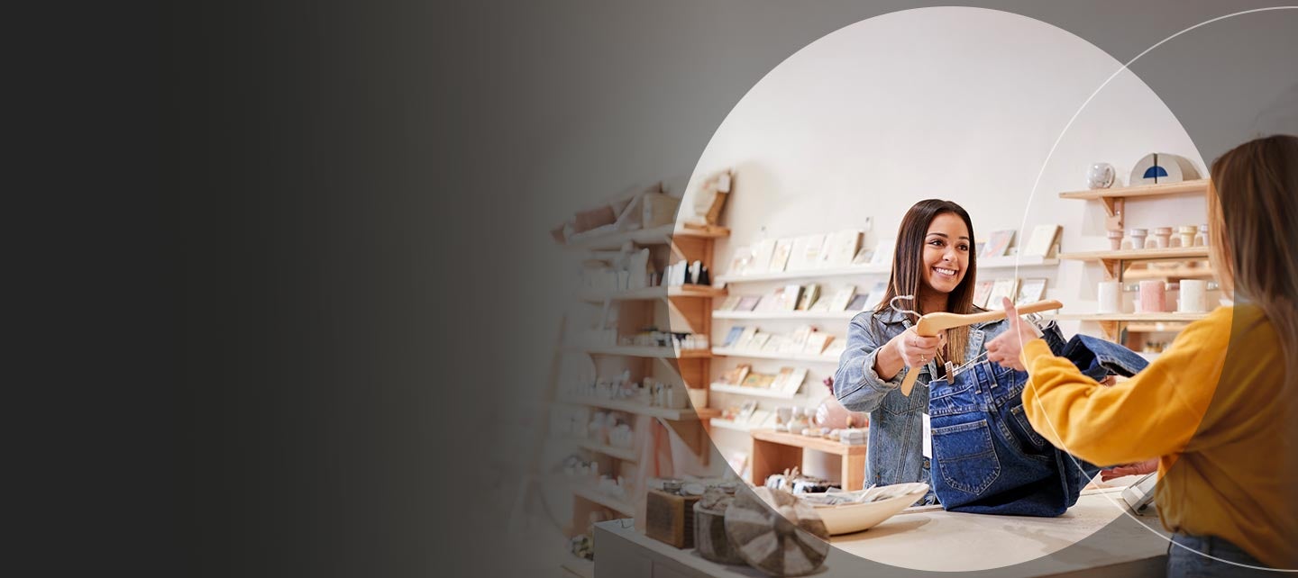A customer buying jeans at store.