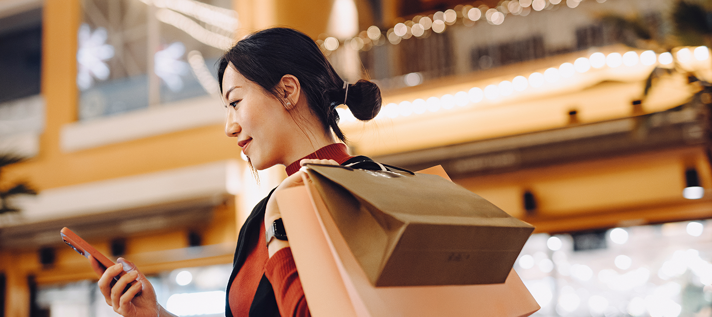 Woman getting a notification after shopping