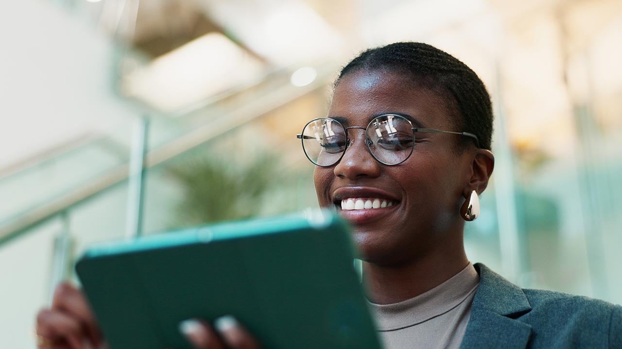 Close up of young woman looking at tablet.