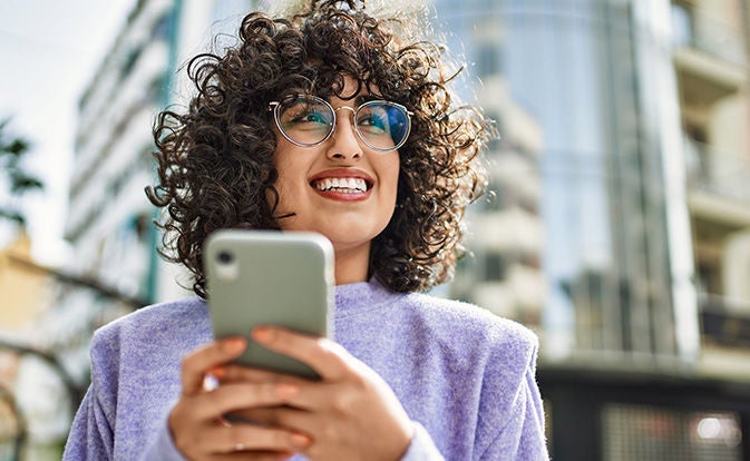 Confident happy woman with phone hand.
