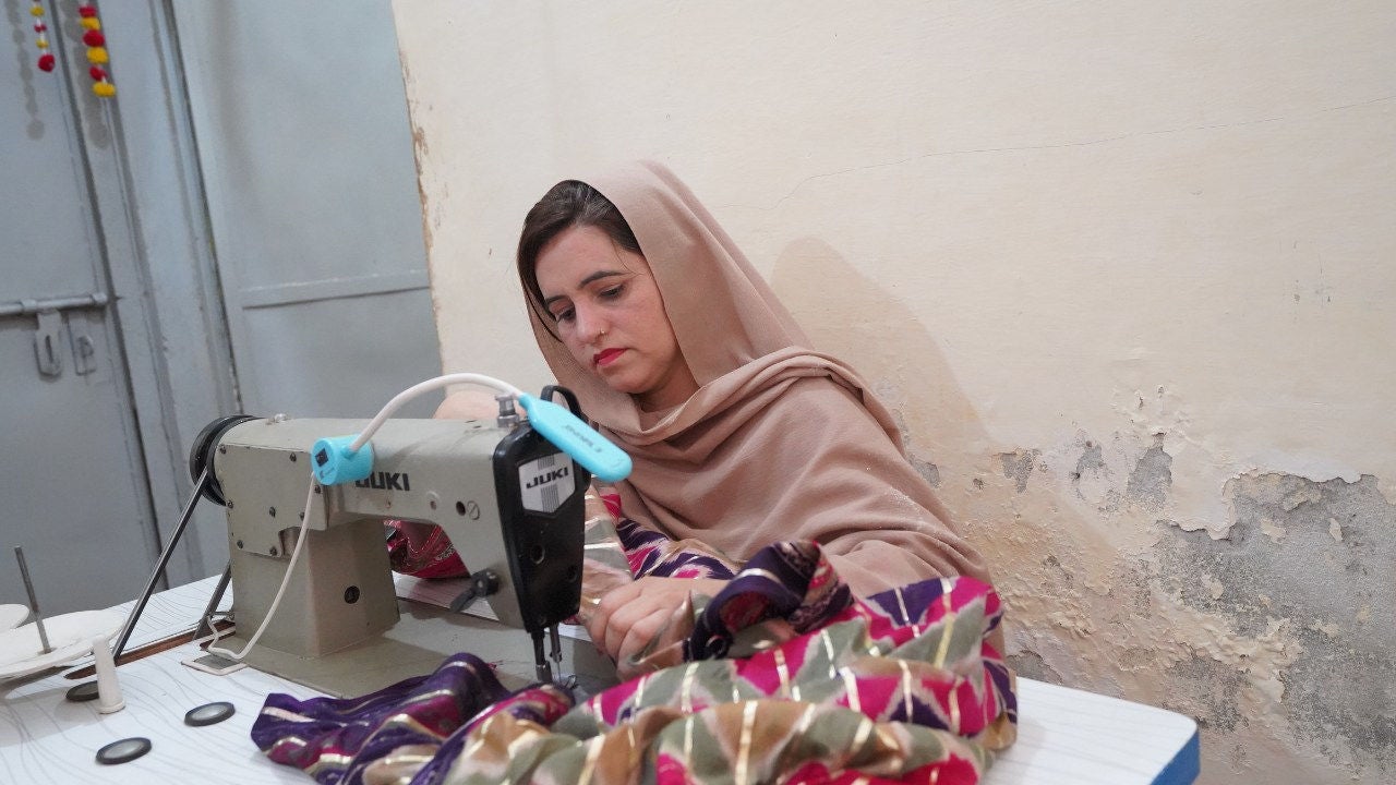 Samina, Multan, Pakistan, embroidering fabric. 
