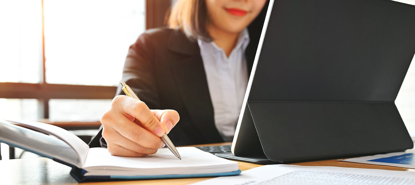 Woman writing at her desk