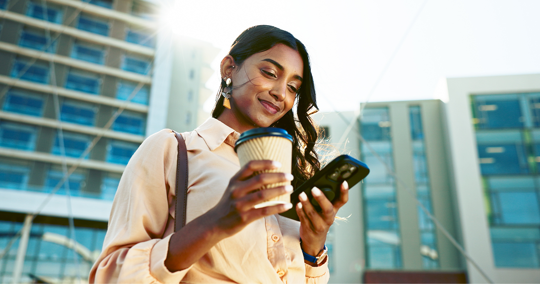 Woman with coffee on her phone