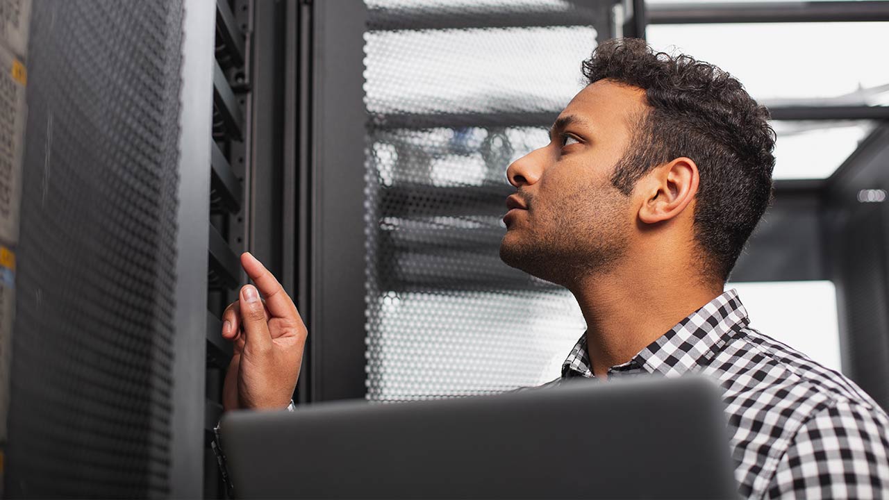 IT guy working in a server room.