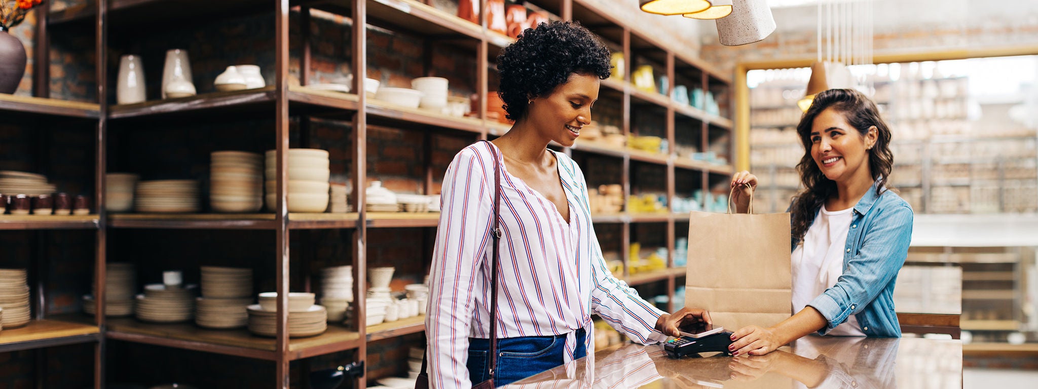 Women finishing a transaction at a boutique