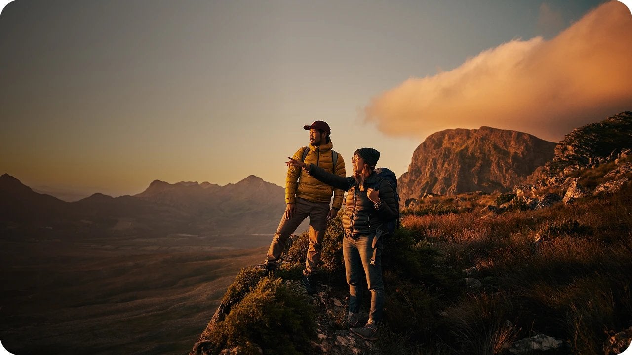 A couple of people standing on a mountain