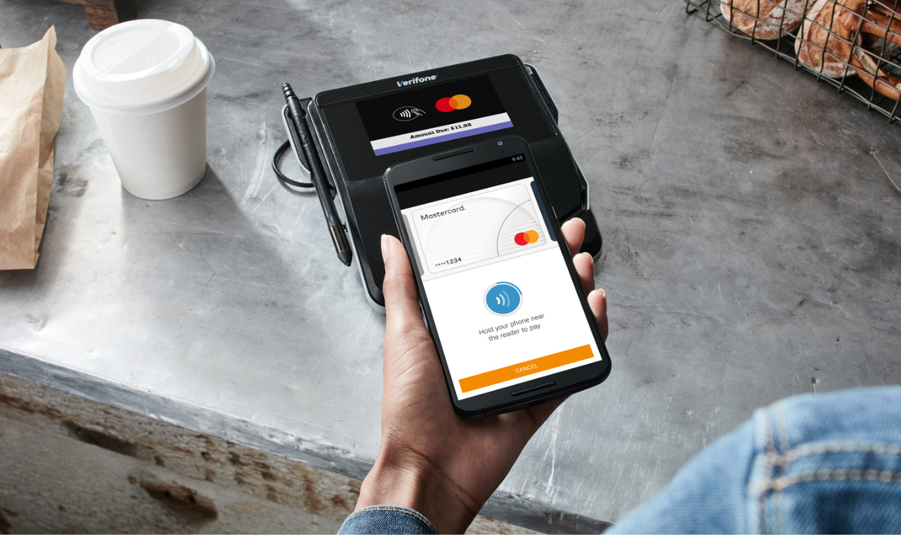 man making contactless payment with smartphone