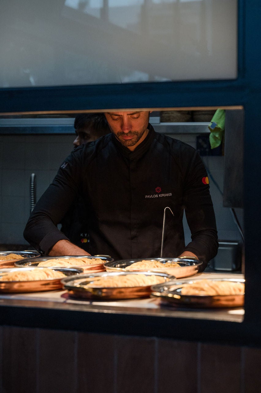 A chef works at the pass in Kykloi by Priceless.