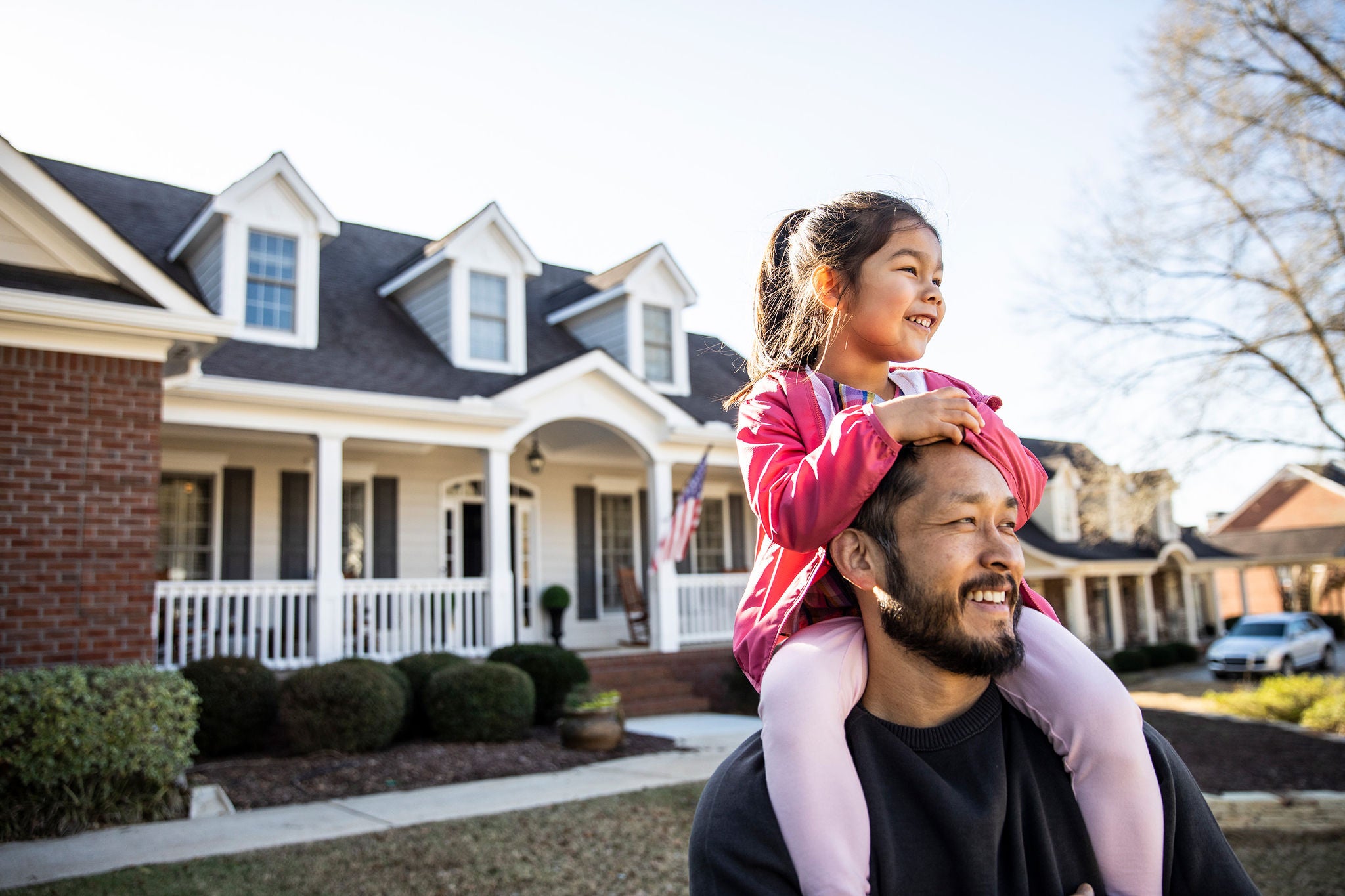 Family standing in front of their new home with an approved mortagage