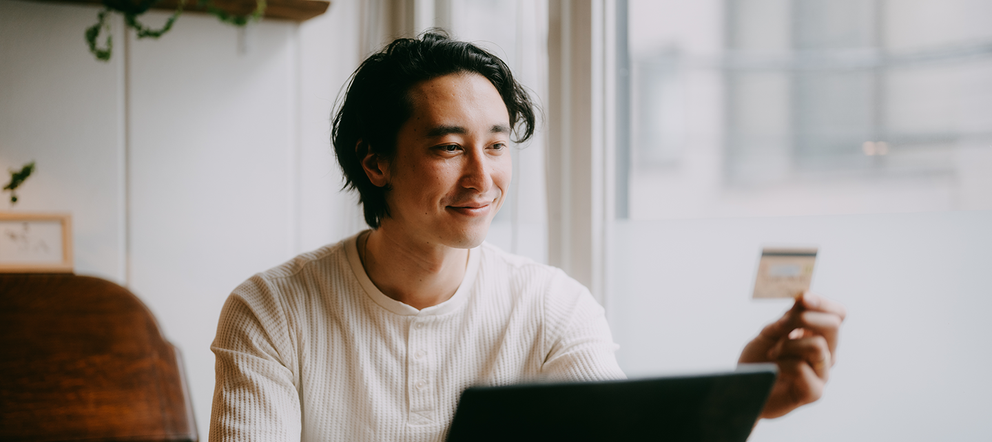 Man buying something on the computer with a card