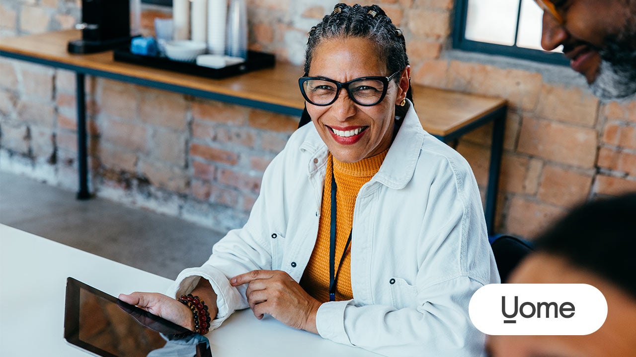 Smiling small business owner. Uome logo.