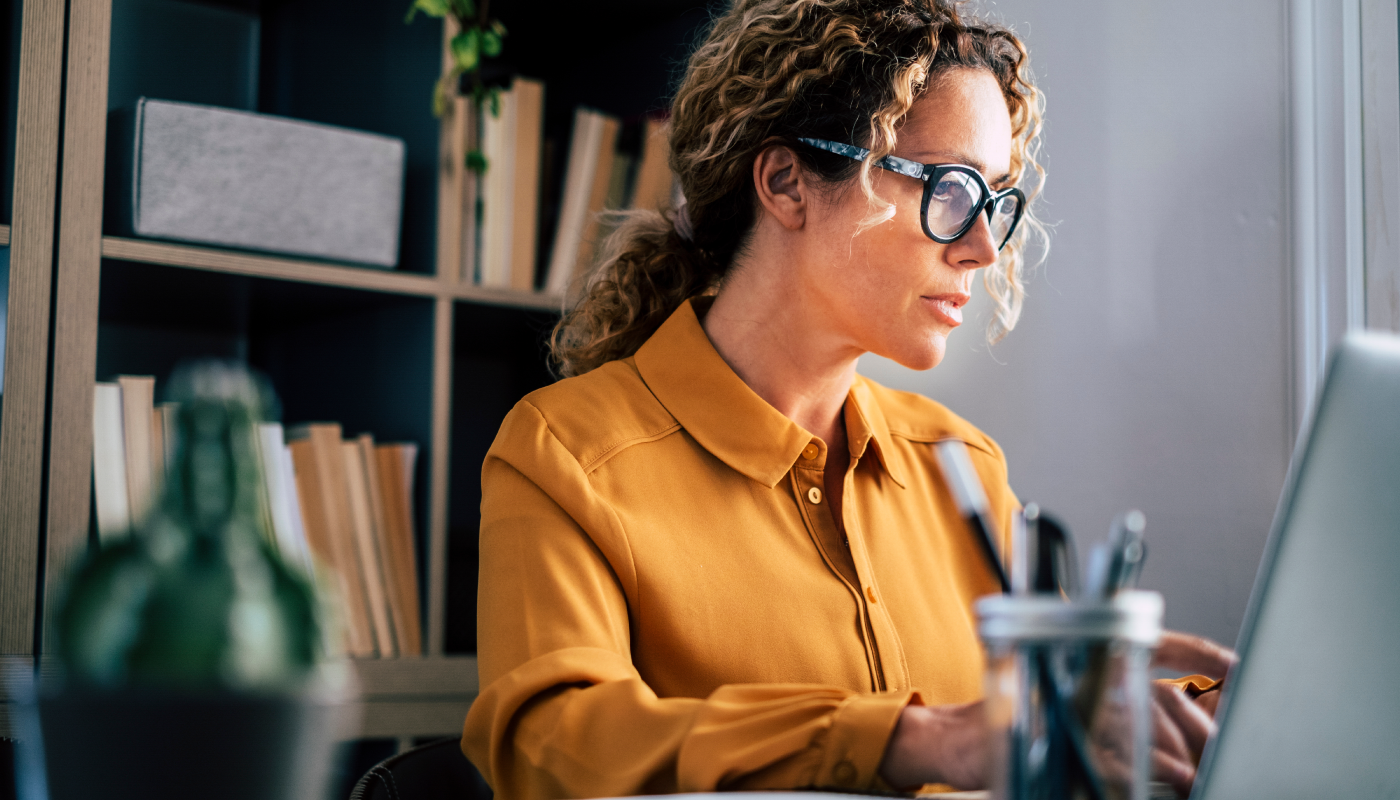 Three women brainstorming in front of a vision board