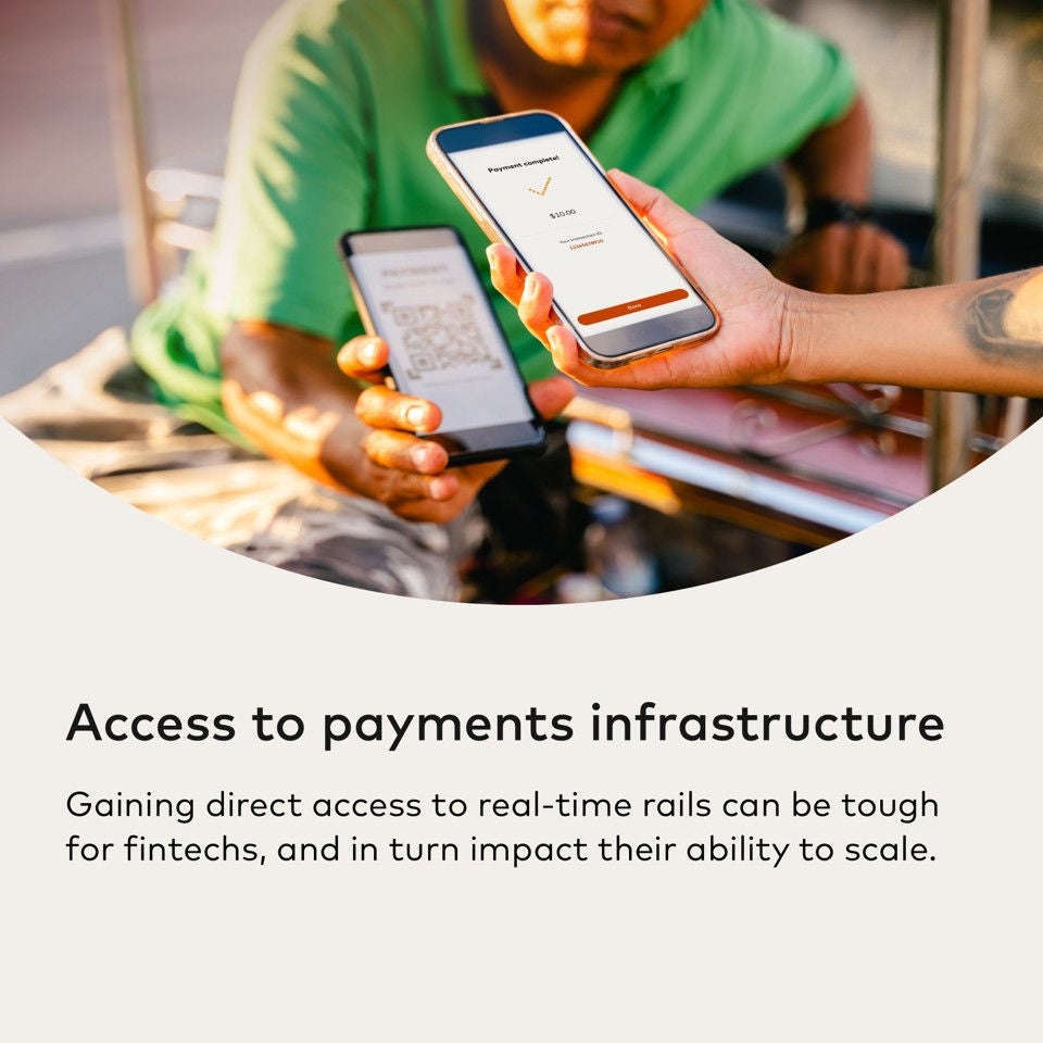 A person in green shirt holds a phone displaying a QR code, while another hand points a phone showing payment confirmation.