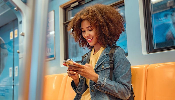 Woman using her phone on the train