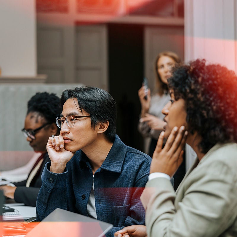 Person pointing to specific data on screens