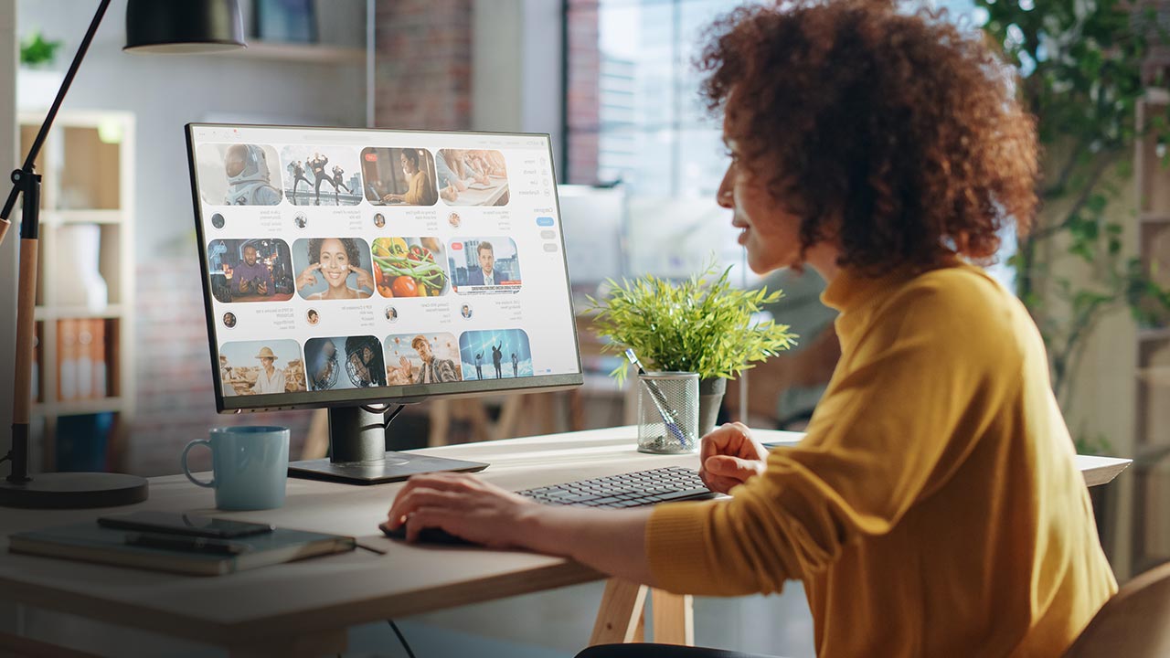 Female working in creative agency, looking through social media trends.