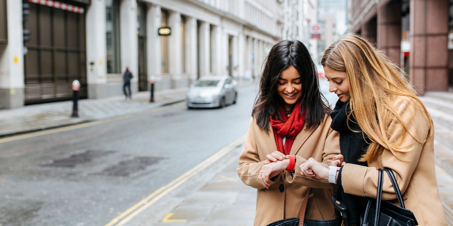 Two women looking at their watches