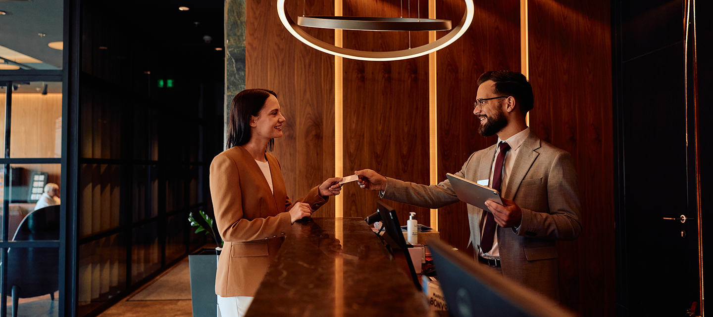 Woman checking in to a hotel