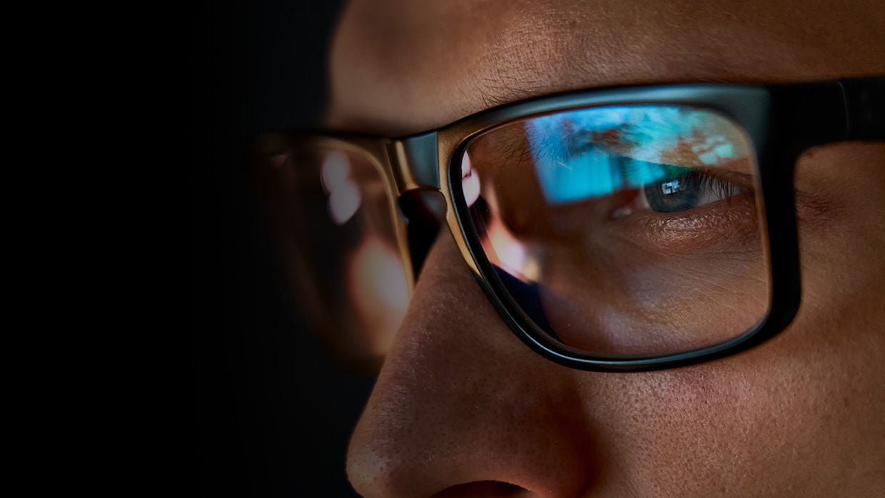 Rear view of mans head wearing headphones.