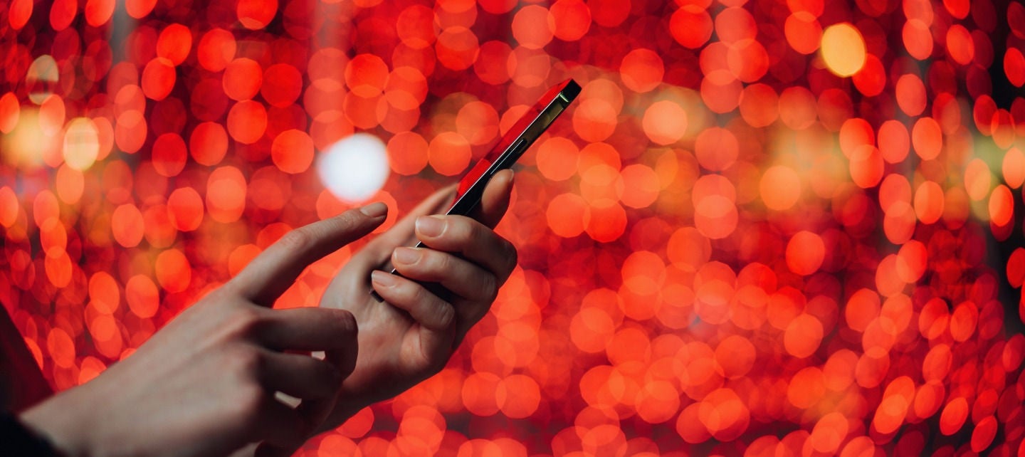 A hand holds a smartphone. 