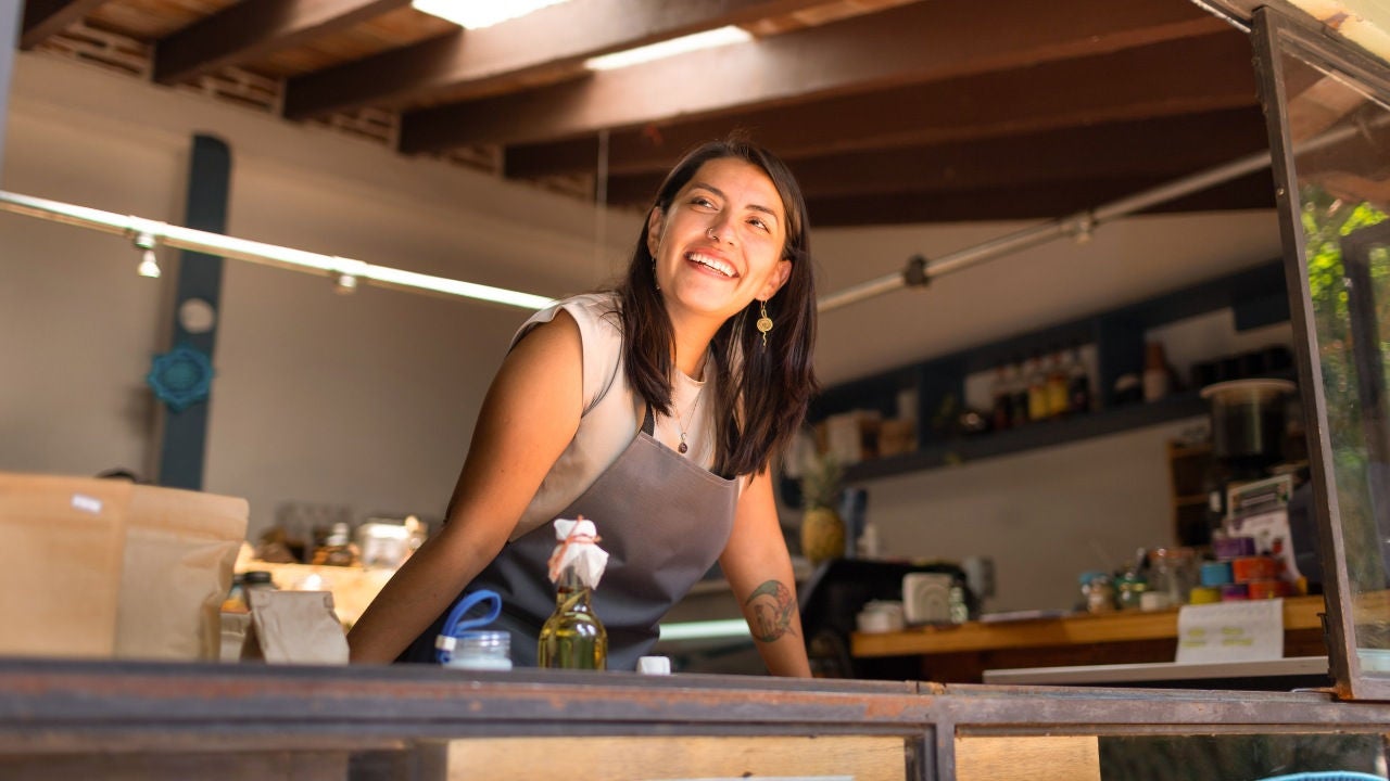 Two kids look at a display in a bakery. 
