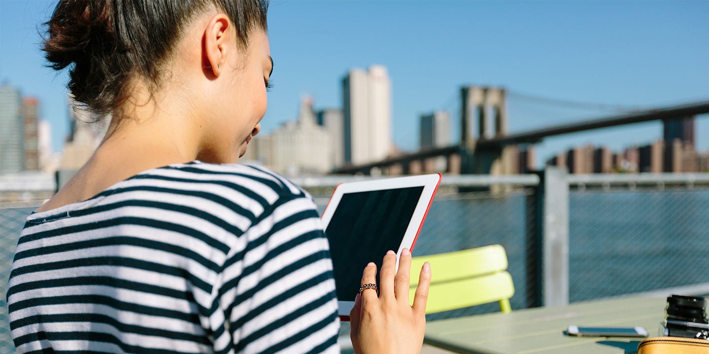USA, New York City, smiling young woman with digital tablet