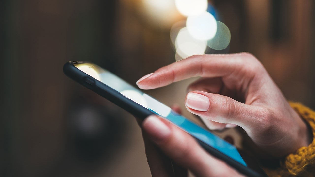 Close up shot of person touching a phone screen.