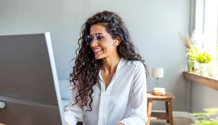 Woman with glasses working on her computer