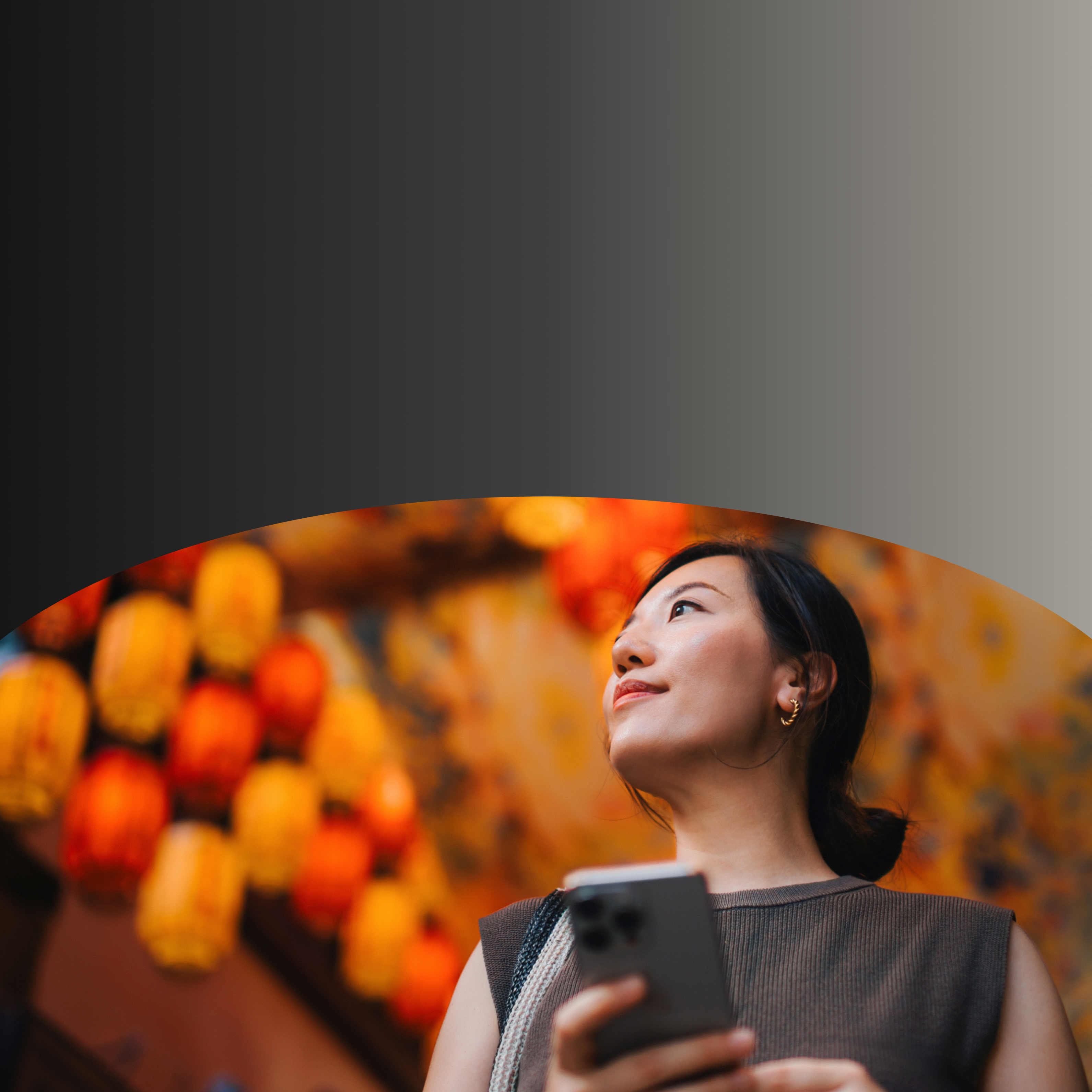Woman in colorful market holding phone