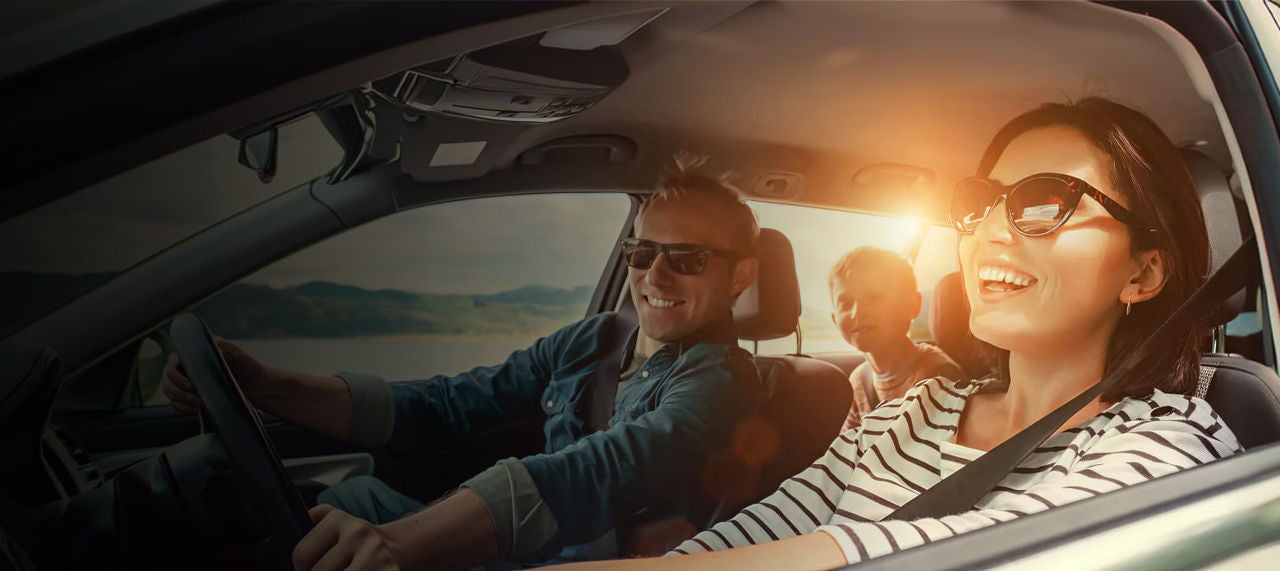 smiling family inside a car
