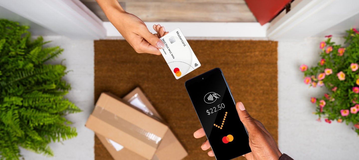 Image depicting the process of using a credit card on a mobile device for transactions.