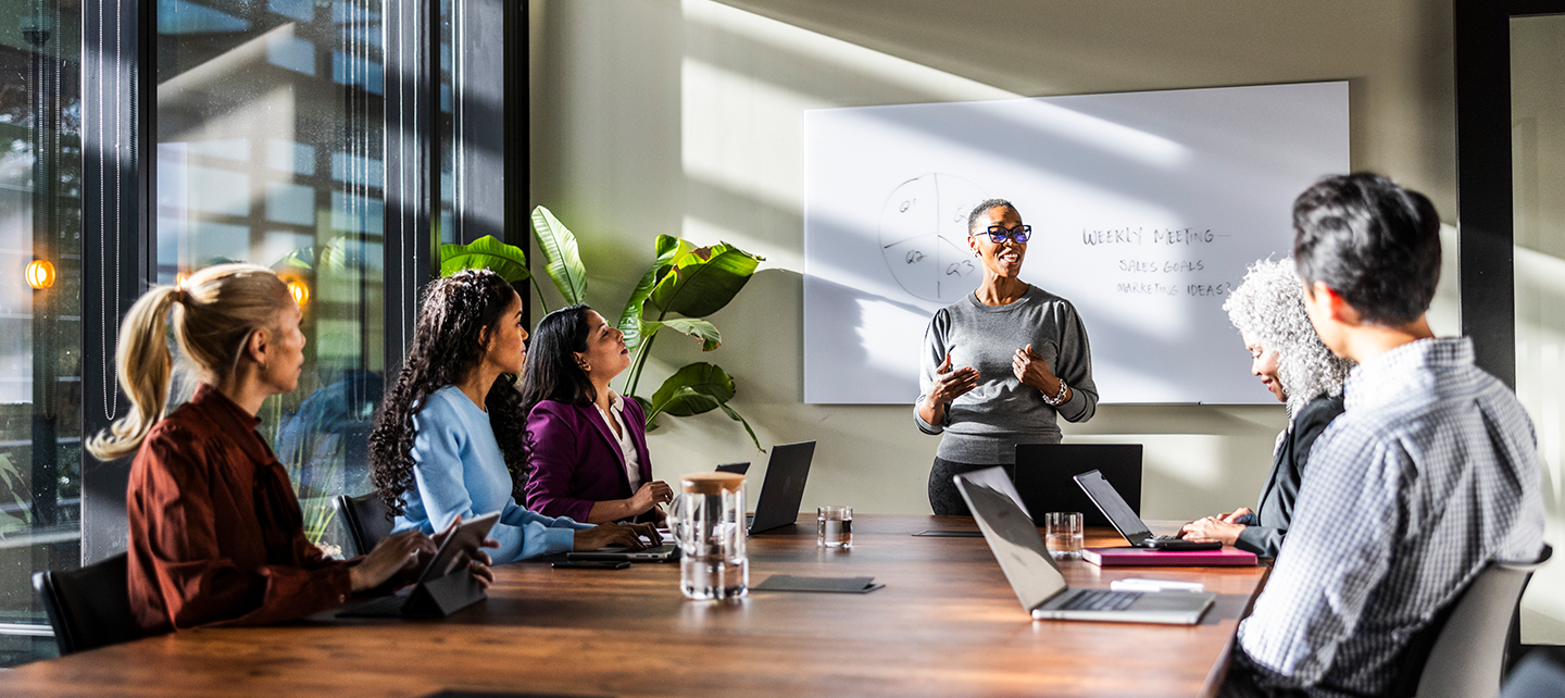 Team meeting around a table in a bright office.
