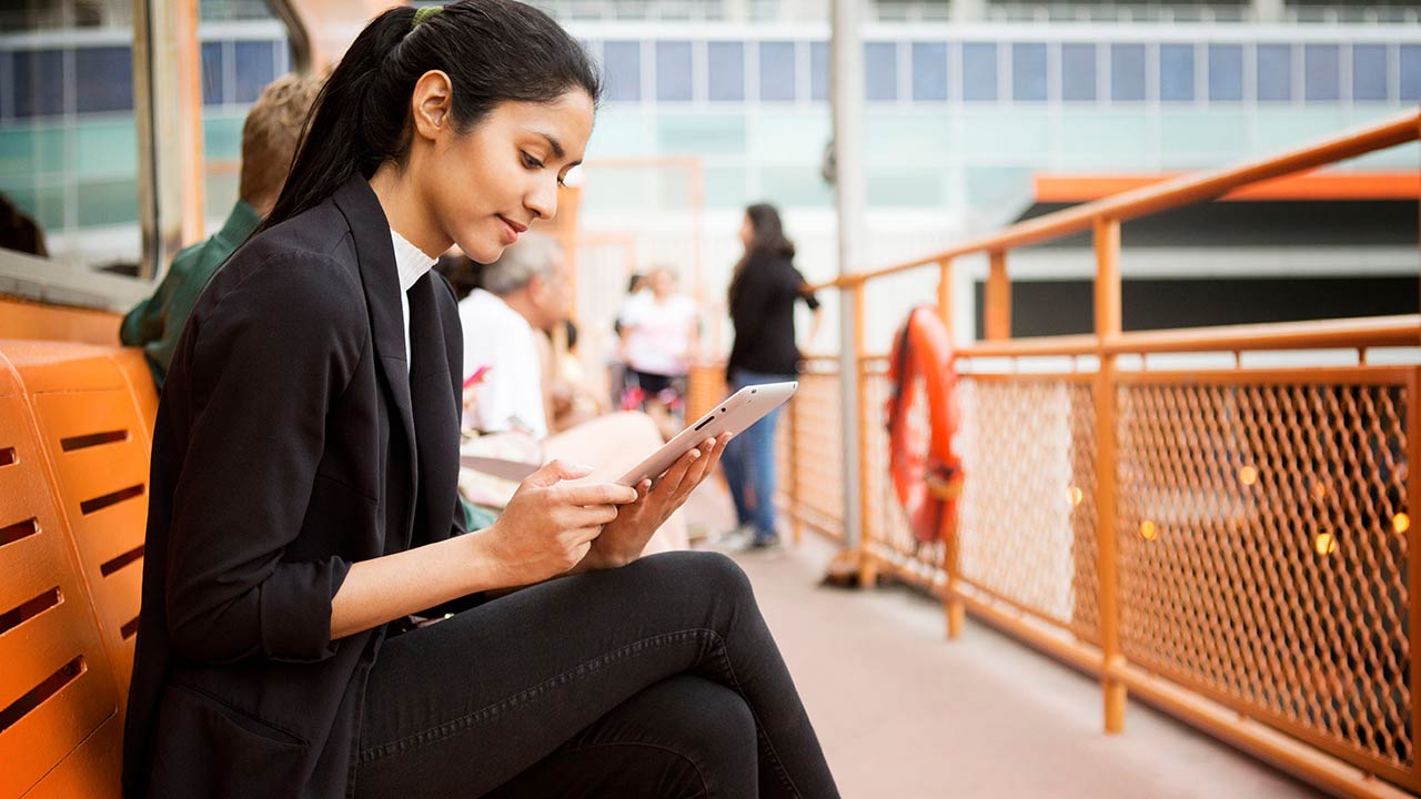 Woman using tablet outside.