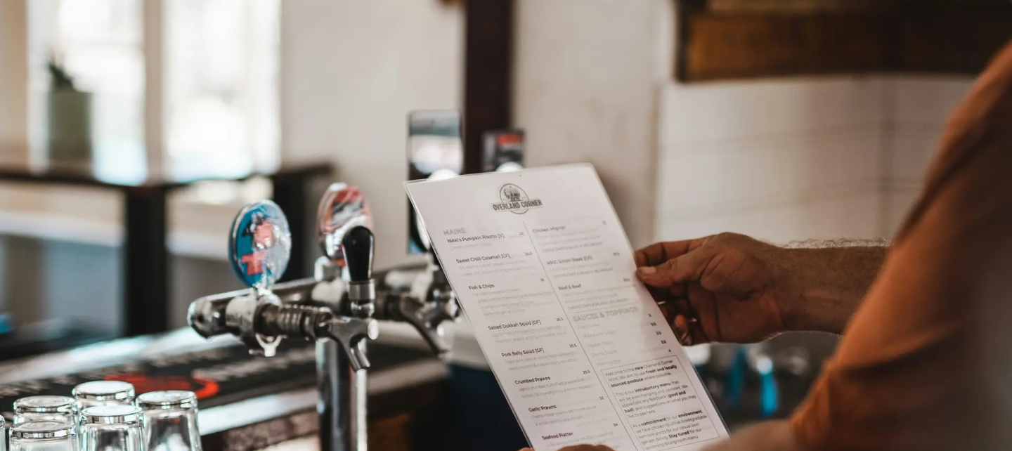 A man holding menucard in hand
