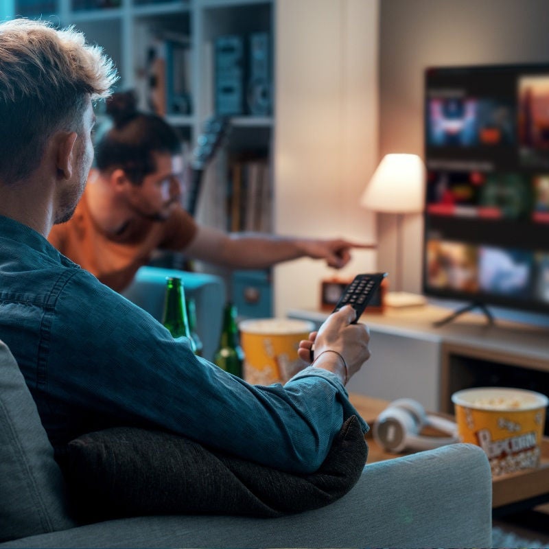 A group of friends watch TV together.