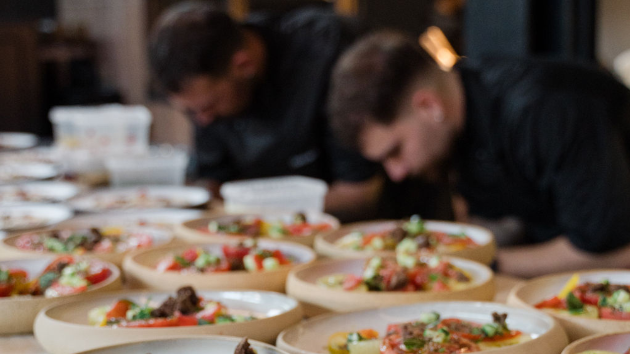 Chefs work on dishes in Kykloi. 