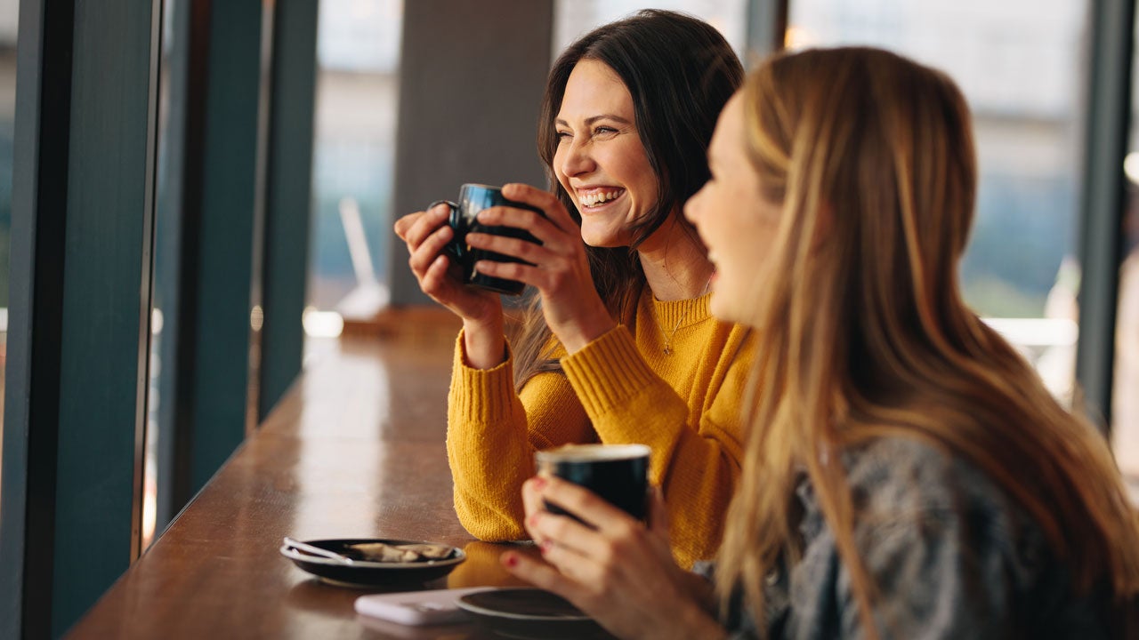Two women laughing together.