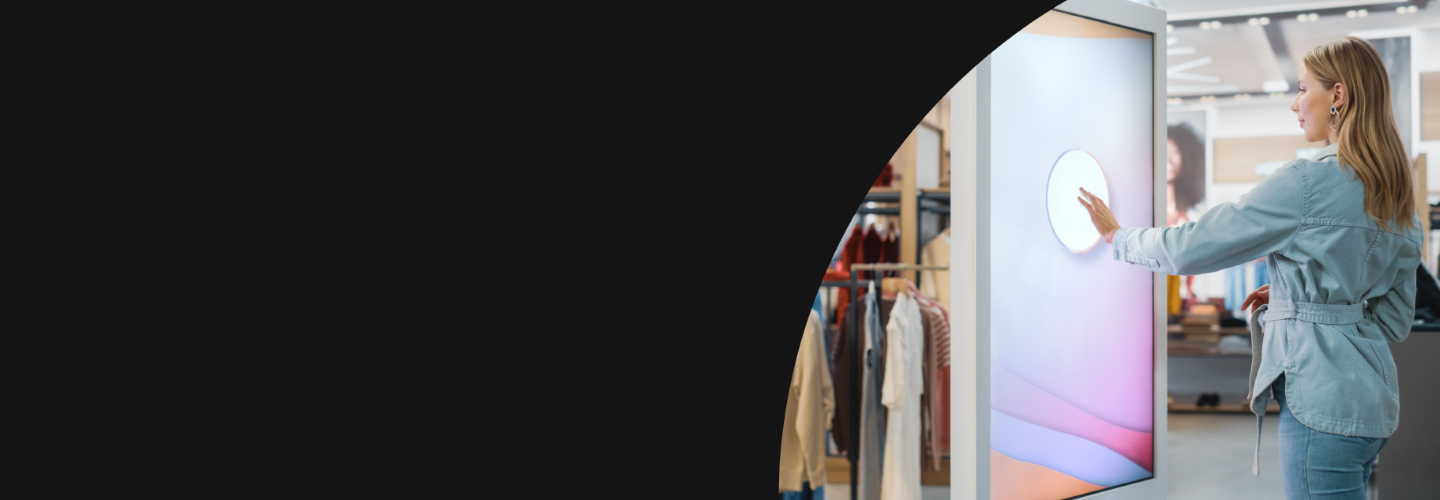 Woman using a large touch screen in a boutique clothing store