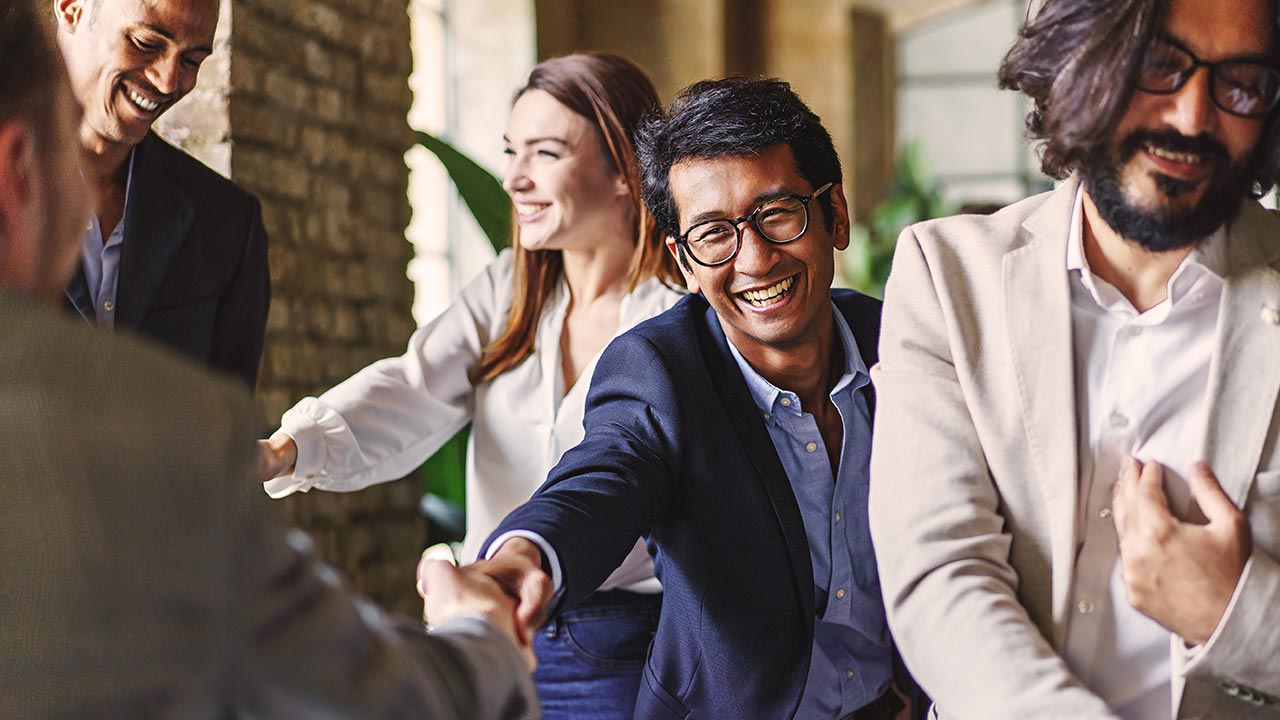 Diverse business team shaking hands.