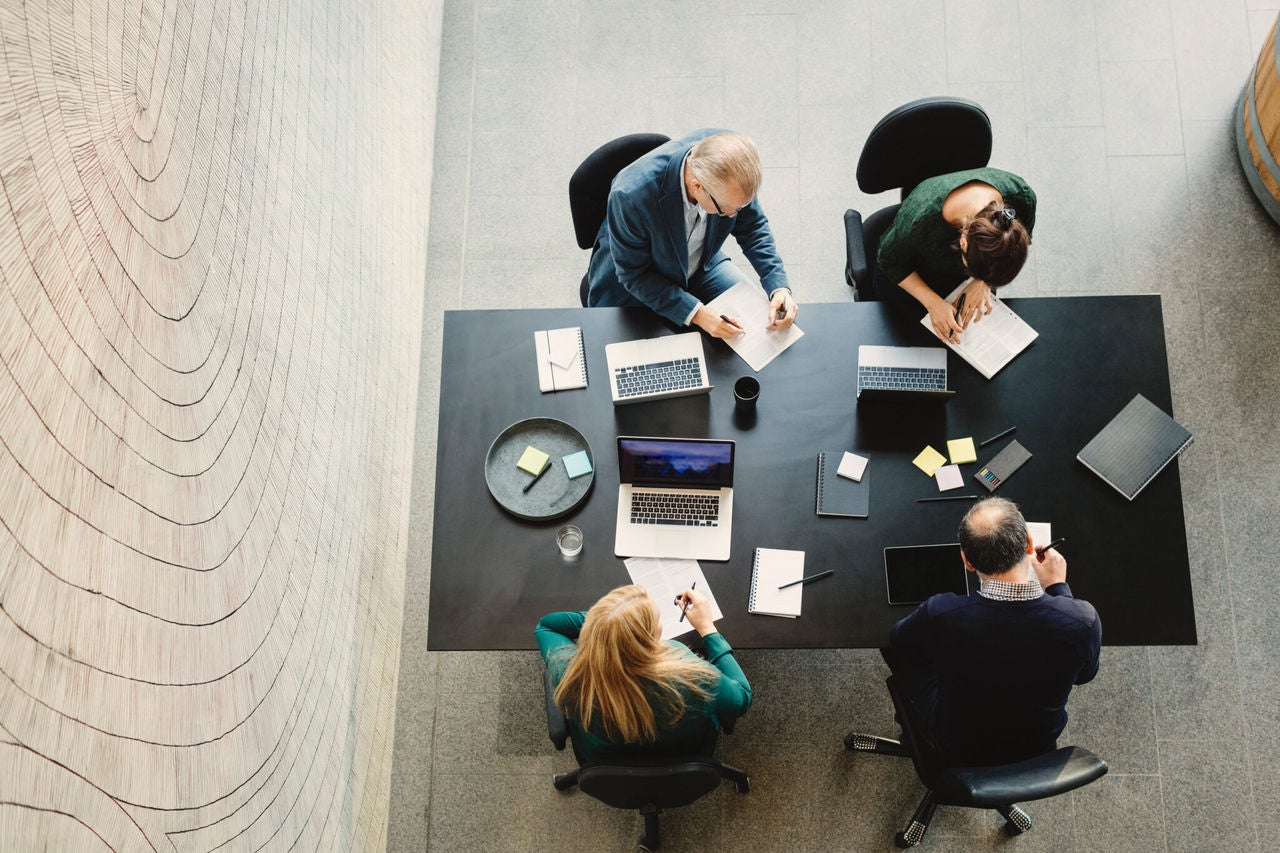 4 persons working at a table