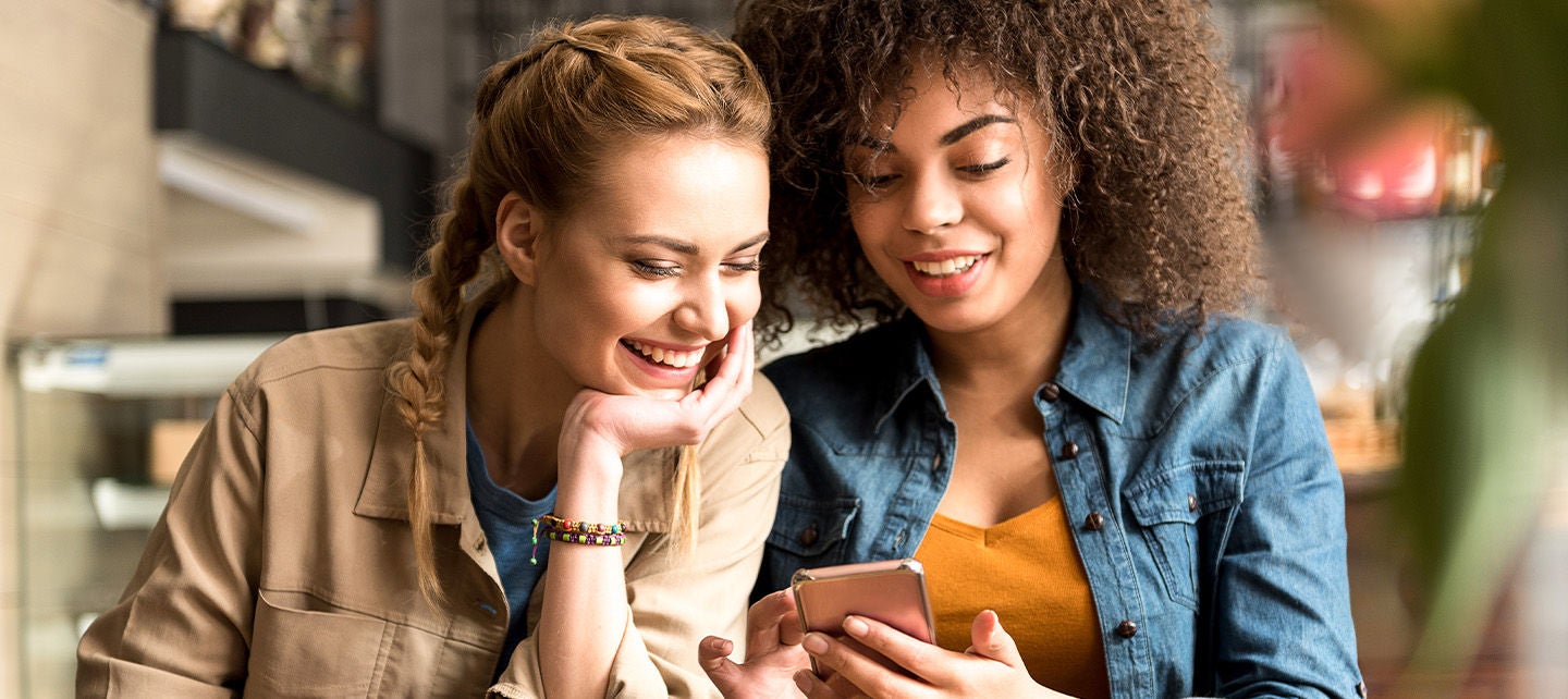 Two women at a restaurant drinking coffee