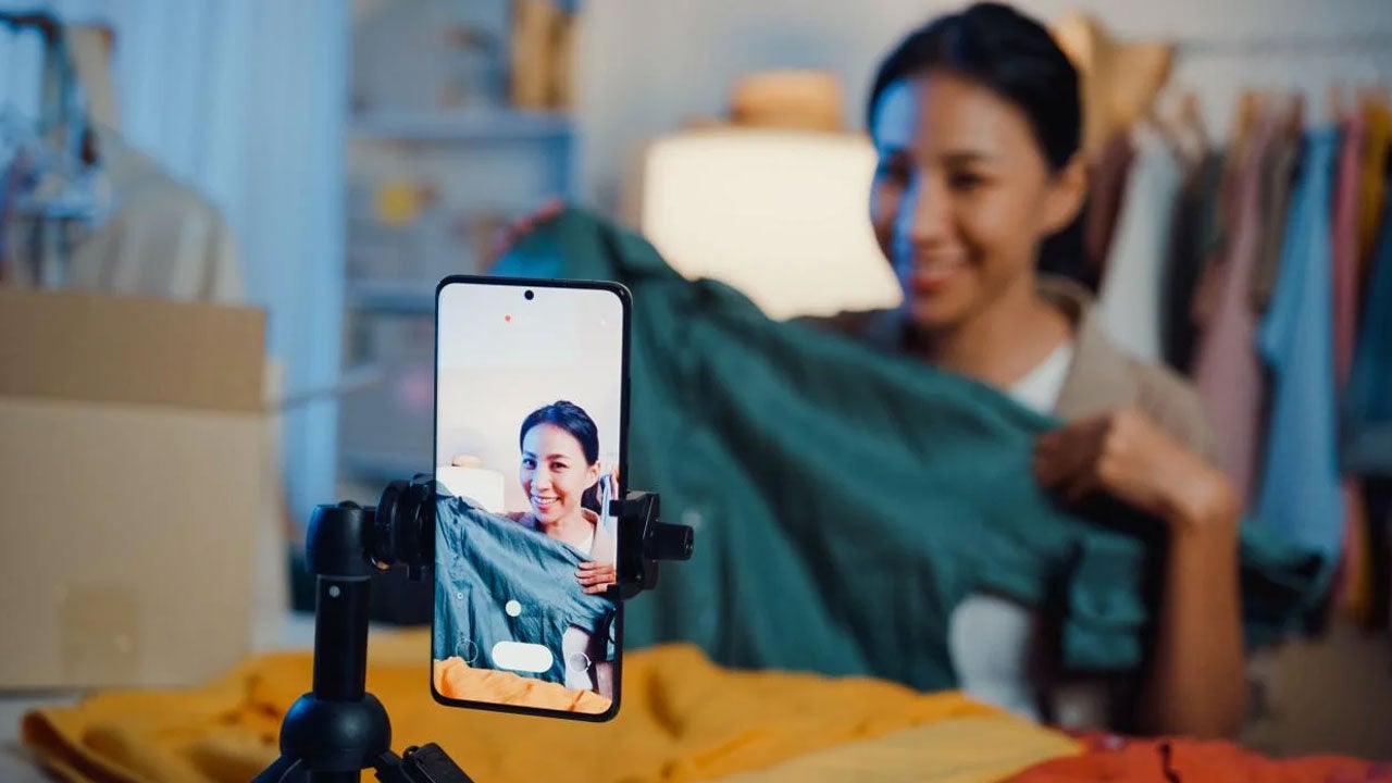 Woman recording video at her store.
