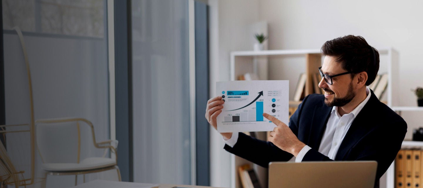 smiling man presenting growth chart
