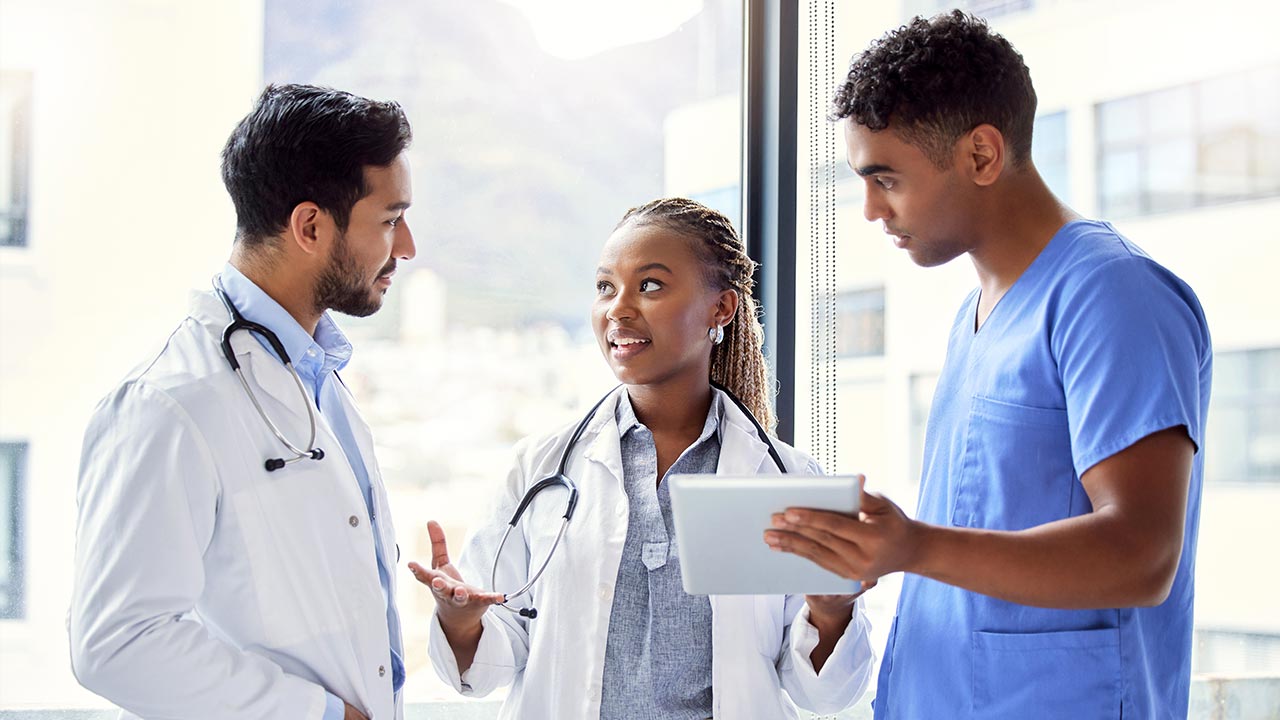 Group of doctors using a digital tablet at work.