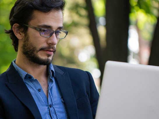 Man reading book in park