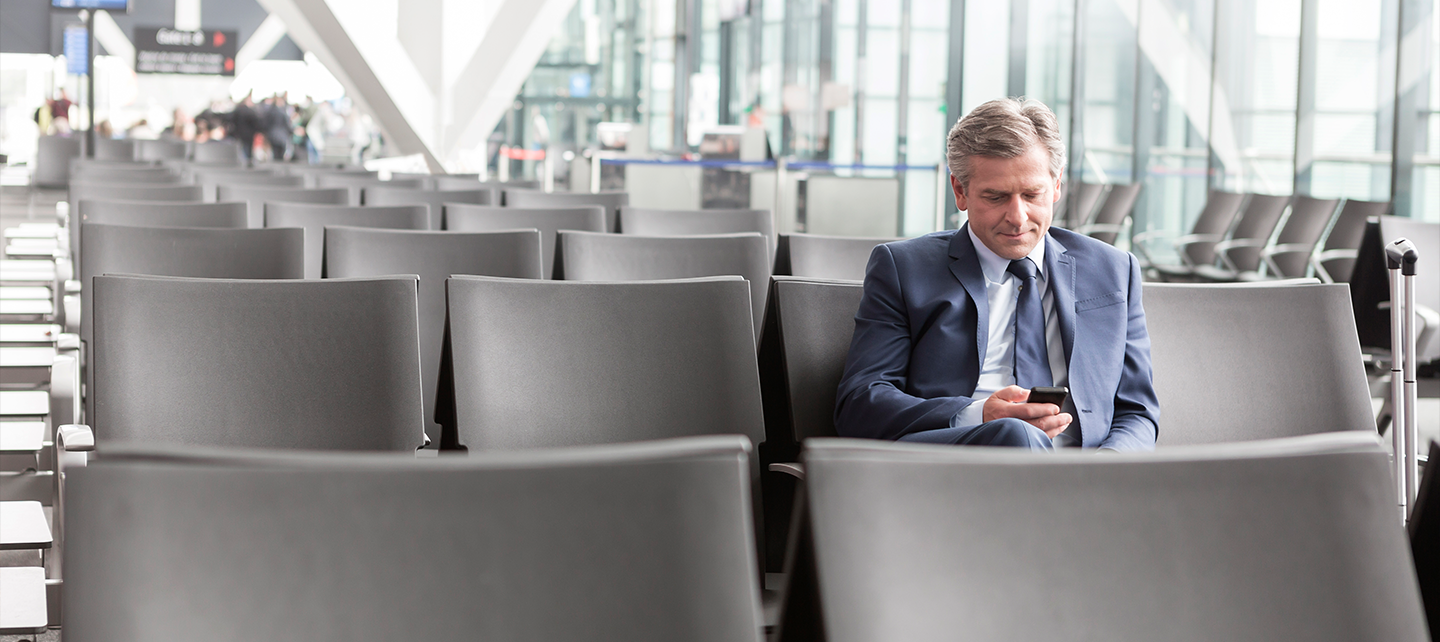 Man looking at phone at the airport