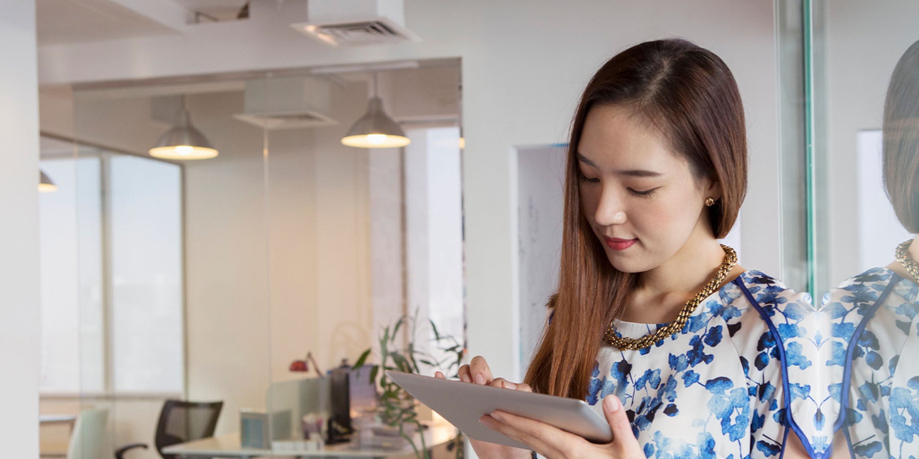 Woman using her tablet at work