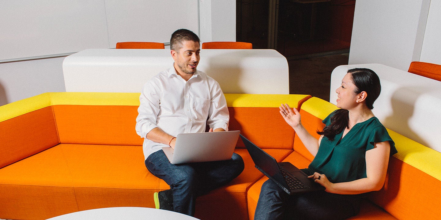 Mastercard empoloyees discussing on the sofa